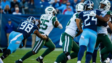 NASHVILLE, TN - DECEMBER 2: Elijah McGuire #25 of the New York Jets runs with the ball while defended by Brian Orakpo #98 of the Tennessee Titans during the first quarter at Nissan Stadium on December 2, 2018 in Nashville, Tennessee. (Photo by Frederick Breedon/Getty Images)