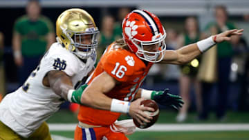 ARLINGTON, TEXAS - DECEMBER 29: Trevor Lawrence #16 of the Clemson Tigers scrambles away from Julian Okwara #42 of the Notre Dame Fighting Irish in the first quarter during the College Football Playoff Semifinal Goodyear Cotton Bowl Classic at AT&T Stadium on December 29, 2018 in Arlington, Texas. (Photo by Ron Jenkins/Getty Images)
