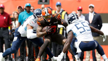 CLEVELAND, OH - SEPTEMBER 8: Odell Beckham Jr. #13 of the Cleveland Browns is tackled by Harold Landry III #58 of the Tennessee Titans and Jayon Brown #55 during the first quarter at FirstEnergy Stadium on September 8, 2019 in Cleveland, Ohio. (Photo by Kirk Irwin/Getty Images)