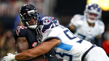 ATLANTA, GA - SEPTEMBER 29: Mohamed Sanu #12 of the Atlanta Falcons is hit by Reggie Gilbert #93 of the Tennessee Titans in the second half of an NFL game at Mercedes-Benz Stadium on September 29, 2019 in Atlanta, Georgia. (Photo by Todd Kirkland/Getty Images)