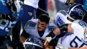 JACKSONVILLE, FLORIDA - SEPTEMBER 19: Marcus Mariota #8 of the Tennessee Titans has his helmet knocked off after being tackled during a game against the Jacksonville Jaguars at TIAA Bank Field on September 19, 2019 in Jacksonville, Florida. (Photo by Mike Ehrmann/Getty Images)