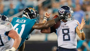 JACKSONVILLE, FLORIDA - SEPTEMBER 19: Josh Allen #41 of the Jacksonville Jaguars forces a fumble by Marcus Mariota #8 of the Tennessee Titans during the fourth quarter of a game at TIAA Bank Field on September 19, 2019 in Jacksonville, Florida. (Photo by James Gilbert/Getty Images)