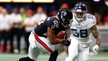ATLANTA, GEORGIA - SEPTEMBER 29: Ito Smith #25 of the Atlanta Falcons rushes against Harold Landry #58 of the Tennessee Titans in the first half at Mercedes-Benz Stadium on September 29, 2019 in Atlanta, Georgia. (Photo by Kevin C. Cox/Getty Images)