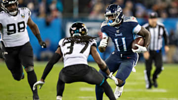 NASHVILLE, TN - NOVEMBER 24: A.J. Brown #11 of the Tennessee Titans runs the ball in the second half and tries to avoid the tackle of Tre Herndon #37 of the Jacksonville Jaguars at Nissan Stadium on November 24, 2019 in Nashville, Tennessee. The Titans defeated the Jaguars 42-20. (Photo by Wesley Hitt/Getty Images)