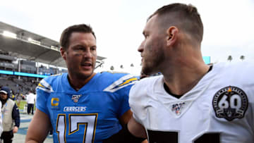 CARSON, CA - DECEMBER 22: Quarterback Philip Rivers #17 of the Los Angeles Chargers walks off the field with inside linebacker Will Compton #51 of the Oakland Raiders after the Raiders defeated the Chargers, 24-17, at Dignity Health Sports Park on December 22, 2019 in Carson, California. (Photo by Kevork Djansezian/Getty Images)