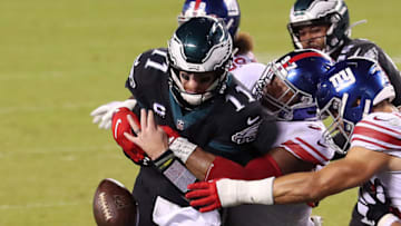 PHILADELPHIA, PENNSYLVANIA- OCTOBER 22: Dexter Lawrence #97 of the New York Giants forces a fumble on Carson Wentz #11 of the Philadelphia Eagles during a two point conversion in the fourth quarter at Lincoln Financial Field on October 22, 2020 in Philadelphia, Pennsylvania. (Photo by Mitchell Leff/Getty Images)