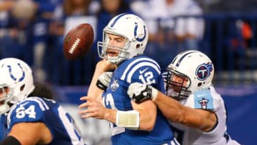 INDIANAPOLIS, IN - DECEMBER 01: Andrew Luck #12 of the Indianapolis Colts fumbles while being tackled by Karl Klug #97 of the Tennessee Titans at Lucas Oil Stadium on December 1, 2013 in Indianapolis, Indiana. (Photo by Gregory Shamus/Getty Images)