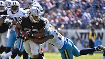 NASHVILLE, TN - SEPTEMBER 25: DeAndre Washington #33 of the Oakland Raiders rushes against the Tennessee Titans during the first half at Nissan Stadium on September 25, 2016 in Nashville, Tennessee. (Photo by Frederick Breedon/Getty Images)