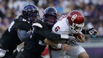 FORT WORTH, TX - OCTOBER 01: Baker Mayfield #6 of the Oklahoma Sooners is tackled by Travin Howard #32 of the TCU Horned Frogs and Josh Carraway #94 in the second half at Amon G. Carter Stadium on October 1, 2016 in Fort Worth, Texas. (Photo by Ronald Martinez/Getty Images)