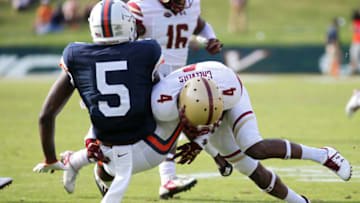 CHARLOTTESVILLE, VA - OCTOBER 21: Hamp Cheevers #4 of the Boston College Eagles tackles Doni Dowling #5 of the Virginia Cavaliers in the fourth quarter during a game at Scott Stadium on October 21, 2017 in Charlottesville, Virginia. (Photo by Ryan M. Kelly/Getty Images)