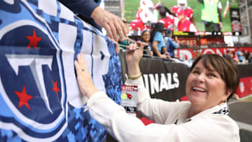 GLENDALE, AZ - DECEMBER 10: Amy Adams Strunk owner of the Tennessee Titans smiles while signing autographs for a fan prior to the NFL game between the Tennessee Titans and Arizona Cardinals at University of Phoenix Stadium on December 10, 2017 in Glendale, Arizona. (Photo by Christian Petersen/Getty Images)