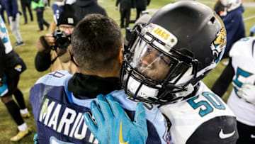 NASHVILLE, TN - DECEMBER 31: Quarterback Marcus Mariota #8 of the Tennessee Titans embraces Linebacker Telvin Smith #50 of the Jacksonville Jaguars following the Titans win at Nissan Stadium on December 31, 2017 in Nashville, Tennessee. (Photo by Shaban Athuman/Getty Images)