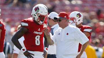 LOUISVILLE, KY - SEPTEMBER 23: Head coach Bobby Petrino of the Louisville Cardinals talks with Lamar Jackson