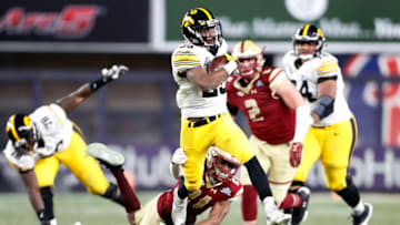 NEW YORK, NY - DECEMBER 27: Akrum Wadley #25 of the Iowa Hawkeyes breaks a tackle attempt by Lukas Denis #21 of the Boston College Eagles during the second half of the New Era Pinstripe Bowl at Yankee Stadium on December 27, 2017 in the Bronx borough of New York City. The Iowa Hawkeyes won 27-20. (Photo by Adam Hunger/Getty Images)