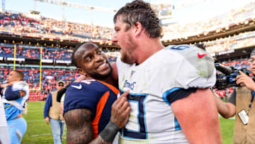 DENVER, CO - OCTOBER 13: Kareem Jackson #22 of the Denver Broncos and Ben Jones #60 of the Tennessee Titans have a word on the field after the Denver Broncos 16-0 win at Empower Field at Mile High on October 13, 2019 in Denver, Colorado. (Photo by Dustin Bradford/Getty Images)