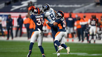 DENVER, CO - SEPTEMBER 14: Corey Davis #84 of the Tennessee Titans makes a contested catch as Justin Simmons #31 and Bryce Callahan #29 of the Denver Broncos cover the play in the third quarter of a game at Empower Field at Mile High on September 14, 2020 in Denver, Colorado. (Photo by Dustin Bradford/Getty Images)