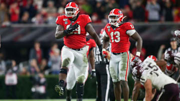 Nov 23, 2019; Athens, GA, USA; Georgia Bulldogs defensive lineman Jordan Davis (99) and linebacker Azeez Ojulari (13) celebrate after a stop against the Texas A&M Aggies in the third quarter at Sanford Stadium. Mandatory Credit: Brett Davis-USA TODAY Sports