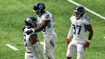 Sep 27, 2020; Minneapolis, Minnesota, USA; Tennessee Titans defensive tackle Jeffery Simmons (left) and inside linebacker Jayon Brown (middle) celebrate a sack by Simmons as safety Amani Hooker (37) looks on against the Minnesota Vikings during the first quarter at U.S. Bank Stadium. Mandatory Credit: Jeffrey Becker-USA TODAY Sports