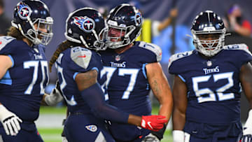 Oct 13, 2020; Nashville, Tennessee, USA; Tennessee Titans running back Derrick Henry (22) celebrates with Tennessee Titans offensive tackle Taylor Lewan (77) after a touchdown during the first half against the Buffalo Bills at Nissan Stadium. Mandatory Credit: Christopher Hanewinckel-USA TODAY Sports
