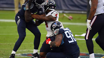 Oct 18, 2020; Nashville, Tennessee, USA; Tennessee Titans outside linebacker Jadeveon Clowney (99) and Tennessee Titans defensive tackle Jeffery Simmons (98) combine to sack Houston Texans quarterback Deshaun Watson (4) during the second half at Nissan Stadium. Mandatory Credit: Christopher Hanewinckel-USA TODAY Sports