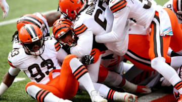 Cincinnati Bengals quarterback Joe Burrow (9), center, is stopped from scoring a touchdown during the first quarter of a Week 7 NFL football game against the Cleveland Browns, Sunday, Oct. 25, 2020, at Paul Brown Stadium in Cincinnati. The Cincinnati Bengals lead the Cleveland Browns 17-10 at halftime.Cincinnati Bengals At Cleveland Browns Oct 25