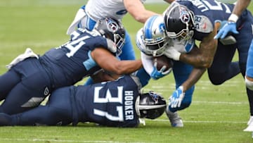 Tennessee Titans defensive end Jack Crawford (94), strong safety Amani Hooker (37) and center Daniel Munyer (52) stop Detroit Lions running back D'Andre Swift (32) during the first quarter at Nissan Stadium Sunday, Dec. 20, 2020 in Nashville, Tenn.Gw58282
