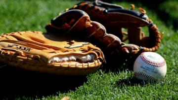 Mar 3, 2014; Surprise, AZ, USA; Detailed view of a baseball and glove on field during Texas Rangers practice at Surprise Stadium. Mandatory Credit: Mark J. Rebilas-USA TODAY Sports