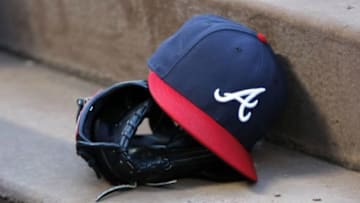 Aug 25, 2015; Atlanta, GA, USA; Detailed view of Atlanta Braves hat and glove in the dugout before a game against the Colorado Rockies at Turner Field. Mandatory Credit: Brett Davis-USA TODAY Sports