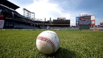 Jul 21, 2015; Atlanta, GA, USA; A baseball, baseball glove and baseballs are shown on the infield during batting practice before the game against the Atlanta Braves and the Los Angeles Dodgers at Turner Field. Mandatory Credit: Jason Getz-USA TODAY Sports
