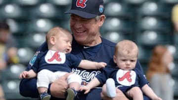 Mar 5, 2016; Lake Buena Vista, FL, USA; Former Atlanta Braves player Dale Murphy poses for a photograph with infants before the start of a spring training game at Champion Stadium. Mandatory Credit: Jonathan Dyer-USA TODAY Sports