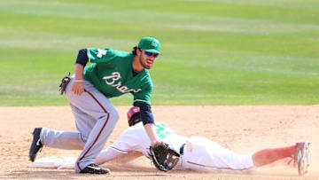 Mar 17, 2016; Melbourne, FL, USA; Washington Nationals left fielder Matt den Dekker (21) slides as Atlanta Braves shortstop Dansby Swanson (80) fields a ball in the ninth inning at Space Coast Stadium. The Washington Nationals won 9-7. Mandatory Credit: Logan Bowles-USA TODAY Sports