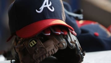 Jul 26, 2014; Atlanta, GA, USA; Detailed view of Atlanta Braves second baseman Tommy La Stella (not pictured) hat and glove in the dugout against the San Diego Padres in the third inning at Turner Field. Mandatory Credit: Brett Davis-USA TODAY Sports