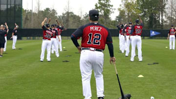 Feb 23, 2015; Lake Buena Vista, FL, USA; Atlanta Braves bullpen coach Eddie Perez (12) watches stretching exercises during spring training workouts at Champion Stadium. Mandatory Credit: Reinhold Matay-USA TODAY Sports