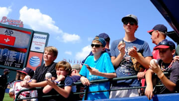 Jun 21, 2015; Atlanta, GA, USA; Fans of the Atlanta Braves seek autographs at the end of the dugout prior to the game agains the New York Mets at Turner Field. Mandatory Credit: Dale Zanine-USA TODAY Sports