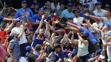 Jun 14, 2015; New York City, NY, USA; New York Mets fans attempt to catch a home run ball hit by Mets catcher Travis d