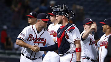 Sep 27, 2016; Atlanta, GA, USA; Atlanta Braves catcher Tyler Flowers (25) and pitching coach Roger McDowell (45) celebrate their win against the Philadelphia Phillies at Turner Field. The Braves won 7-6. Mandatory Credit: Jason Getz-USA TODAY Sports