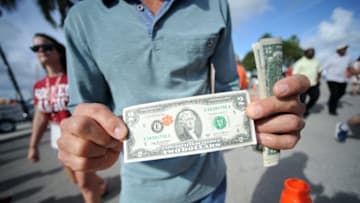 Dec 31, 2015; Miami Gardens, FL, USA; A Clemson Tigers fan holds a 2 dollar bills prior to the 2015 CFP semifinal at the Orange Bowl against the Oklahoma Sooners at Sun Life Stadium. Mandatory Credit: Robert Duyos-USA TODAY Sports