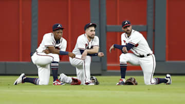 ATLANTA, GA - JULY 26: Outfielders (from left to right ) Ronald Acuna, Jr. #13, Ender Inciarte #11 and right fielder Nick Markakis #22 of the Atlanta Braves kneel during a pitching change in the seventh inning during the game against the Los Angeles Dodgers at SunTrust Park on July 26, 2018 in Atlanta, Georgia. (Photo by Mike Zarrilli/Getty Images)
