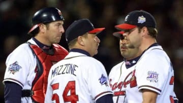 Kevin Millwood of the Atlanta Braves in visited on the mound by pitching coach Leo Mazzone . (Photo credit should read JEFF HAYNES/AFP via Getty Images)