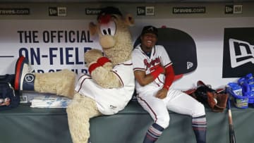 ATLANTA, GA - JULY 31: Atlanta Braves mascot Blooper and left fielder Ronald Acuna, Jr. #13 play around in the dugout during a rain delay before the game against the Miami Marlins at SunTrust Park on July 31, 2018 in Atlanta, Georgia. (Photo by Mike Zarrilli/Getty Images)