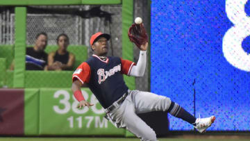 MIAMI, FL - AUGUST 26: Ronald Acuna Jr. #13 of the Atlanta Braves makes a sliding catch during the seventh inning against the Miami Marlins at Marlins Park on August 26, 2018 in Miami, Florida. All players across MLB will wear nicknames on their backs as well as colorful, non-traditional uniforms featuring alternate designs inspired by youth-league uniforms during Players Weekend. (Photo by Eric Espada/Getty Images)
