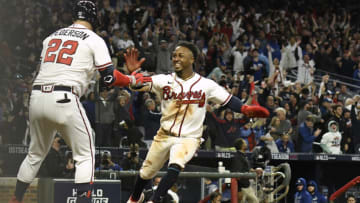 ATLANTA, GEORGIA - OCTOBER 16: Ozzie Albies #1 of the Atlanta Braves celebrates with Joc Pederson #22 after scoring the winning run on a walk-off RBI single by Austin Riley #27 (not pictured) during the ninth inning of Game One of the National League Championship Series at Truist Park on October 16, 2021 in Atlanta, Georgia. (Photo by Edward M. Pio Roda/Getty Images)