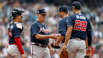 SEATTLE, WASHINGTON - SEPTEMBER 11: Manager Brian Snitker #43 of the Atlanta Braves takes pitcher Jake Odorizzi #12 out of the game during the fourth inning against the Seattle Mariners at T-Mobile Park on September 11, 2022 in Seattle, Washington. (Photo by Steph Chambers/Getty Images)