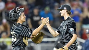 Omaha, NE - JUNE 22: Pitcher Kyle Wright #44 of the Vanderbilt Commodores celebrates with catcher Karl Ellison #25 after beating the Virginia Cavaliers 5-1 during game one of the College World Series Championship Series on June 22, 2015 at TD Ameritrade Park in Omaha, Nebraska. (Photo by Peter Aiken/Getty Images)