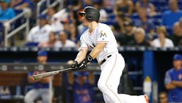 MIAMI, FL - AUGUST 12: J.T. Realmuto #11 of the Miami Marlins singles in the ninth inning against the New York Mets at Marlins Park on August 12, 2018 in Miami, Florida. (Photo by Michael Reaves/Getty Images)