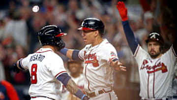 Oct 23, 2021; Cumberland, Georgia, USA; Atlanta Braves left fielder Eddie Rosario (8) celebrates with third baseman Ehire Adrianza (23) after hitting three run home run during the fourth inning against the Los Angeles Dodgers in game six of the 2021 NLCS at Truist Park. Mandatory Credit: Brett Davis-USA TODAY Sports