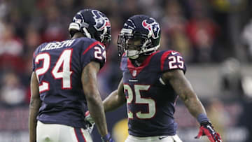 Dec 28, 2014; Houston, TX, USA; Houston Texans cornerback Johnathan Joseph (24) is congratulated by cornerback Kareem Jackson (25) after making a defensive play during the second quarter against the Jacksonville Jaguars at NRG Stadium. Mandatory Credit: Troy Taormina-USA TODAY Sports