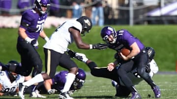 Nov 14, 2015; Evanston, IL, USA; Northwestern Wildcats quarterback Clayton Thorson (18) is tackled by Purdue Boilermakers defensive tackle Ra