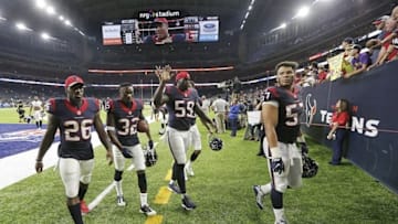 Aug 20, 2016; Houston, TX, USA; Houston Texans running back Lamar Miller (26) defensive back Robert Nelson (32) outside linebacker Whitney Mercilus (59) linebacker Brennan Scarlett (57) wave as they walk off the field after defeating the New Orleans Saints in the second half at NRG Stadium. Texans won 16-9. Mandatory Credit: Thomas B. Shea-USA TODAY Sports