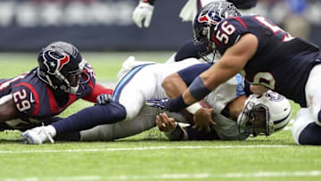 Oct 2, 2016; Houston, TX, USA; Tennessee Titans quarterback Marcus Mariota (8) is tackled by Houston Texans free safety Andre Hal (29) and inside linebacker Brian Cushing (56) during the first half at NRG Stadium. Mandatory Credit: Kevin Jairaj-USA TODAY Sports